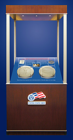 Showcase with the United States Mint Logo which displays a pencil sketch of an early design idea by Augustus Saint-Gaudens, an image of Augustus Saint-Gaudens, the final plaster of the sculpture that was used in1907 for test specimens, and the digital mapped plasters.