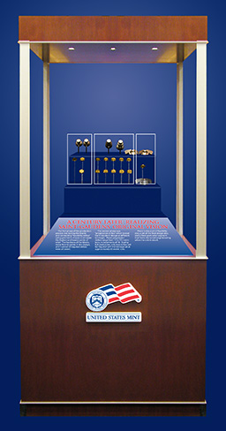 Showcase with the United States Mint logo displays the blanks used for testing and conducting "feasibility strikes" using geometric shapes to simulate the highest and lowest points of relief, "progression strikes" which tested Saint-Gaudens’ design at different tonnages. There is also a set of feasibility dies, a set of the final design dies, and a three-part collar segment that forms the raised edge lettering when the coin is struck. 
