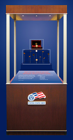 Showcase with the United States Mint Logo which displays the finished coins and the prototype packaging.